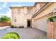 Inviting front exterior with a two car garage, desert landscaping, and charming architectural detail at 100 Samantha Rose St, Henderson, NV 89012