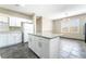 Open kitchen features white cabinets, a granite countertop island, and stainless steel appliances at 100 Samantha Rose St, Henderson, NV 89012