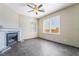 A comfortable living room with fireplace, ceiling fan, and natural light through shuttered windows at 100 Samantha Rose St, Henderson, NV 89012