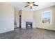 Living room area with stylish ceiling fan, large window, and cozy fireplace feature at 100 Samantha Rose St, Henderson, NV 89012