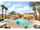 Resort-style community pool with lush landscaping, lounge chairs, and a covered area at 100 Samantha Rose St, Henderson, NV 89012