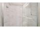 Modern shower with marble tile, glass door, and sleek showerhead at 100 Samantha Rose St, Henderson, NV 89012