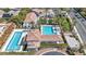 Aerial view showcasing the community pools and well-maintained landscaping, providing a resort-like atmosphere at 10213 Treasure Mountain Ct, Las Vegas, NV 89129