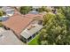 Aerial view showcases a home's tile roof, covered patio, and well-manicured backyard at 10213 Treasure Mountain Ct, Las Vegas, NV 89129