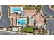 Aerial view of resort-style community pool with palm trees and putting green at 10213 Treasure Mountain Ct, Las Vegas, NV 89129