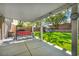 Spacious backyard with covered patio, swing set, and lush green lawn at 10213 Treasure Mountain Ct, Las Vegas, NV 89129