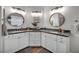 Bathroom with double vanity sinks, white cabinets, and modern fixtures at 10213 Treasure Mountain Ct, Las Vegas, NV 89129