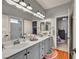 Bathroom with double sinks and cabinets, mirrors and a view into the bedrooms at 10213 Treasure Mountain Ct, Las Vegas, NV 89129