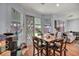 Cozy dining area with a wooden table, chairs, and sliding glass doors to the backyard at 10213 Treasure Mountain Ct, Las Vegas, NV 89129