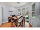 Charming dining area features a wooden table with backyard views through sliding glass doors at 10213 Treasure Mountain Ct, Las Vegas, NV 89129