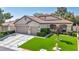 Charming single-story home with a well-manicured lawn, mature landscaping, and a three-car garage at 10213 Treasure Mountain Ct, Las Vegas, NV 89129