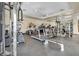 Well-lit gym with treadmills, weight machines, and mirrored wall at 10213 Treasure Mountain Ct, Las Vegas, NV 89129