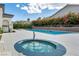 Inviting community hot tub and pool area featuring sparkling water and comfortable lounging space for relaxation at 10213 Treasure Mountain Ct, Las Vegas, NV 89129