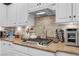 Well-equipped kitchen featuring granite countertops, a tile backsplash, and modern appliances at 10213 Treasure Mountain Ct, Las Vegas, NV 89129