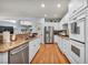 Updated kitchen featuring stainless steel appliances, granite countertops, and hardwood floors at 10213 Treasure Mountain Ct, Las Vegas, NV 89129
