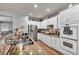 Modern kitchen with white cabinets, stainless steel appliances, and granite countertops at 10213 Treasure Mountain Ct, Las Vegas, NV 89129