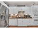 Bright kitchen featuring stainless steel appliances, white cabinetry, and a decorative backsplash at 10213 Treasure Mountain Ct, Las Vegas, NV 89129