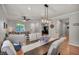 Open-concept living and dining area with modern lighting and ample seating at 10213 Treasure Mountain Ct, Las Vegas, NV 89129