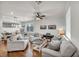 Bright living room featuring modern furnishings, hardwood floors, and plenty of natural light for comfortable living at 10213 Treasure Mountain Ct, Las Vegas, NV 89129