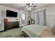 Serene main bedroom with a ceiling fan, dresser, and ensuite bathroom access at 10213 Treasure Mountain Ct, Las Vegas, NV 89129