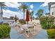 Outdoor kitchen area with barbecue, seating, and lush green landscaping at 10213 Treasure Mountain Ct, Las Vegas, NV 89129