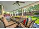 Covered patio features an outdoor dining set, lush backyard views, and charming string lights at 10213 Treasure Mountain Ct, Las Vegas, NV 89129