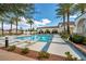 Beautiful community pool surrounded by palm trees, lounge chairs, and tiled deck at 10213 Treasure Mountain Ct, Las Vegas, NV 89129