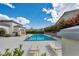 Relaxing community pool with lounge chairs, surrounded by lush greenery and offering a refreshing amenity at 10213 Treasure Mountain Ct, Las Vegas, NV 89129