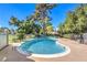 Community pool featuring crystal clear water, a lounge area, and privacy fencing at 1030 Tam O Shanter, Las Vegas, NV 89109