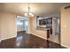 Inviting dining area open to the kitchen, featuring hardwood floors and stylish lighting at 1030 Tam O Shanter, Las Vegas, NV 89109