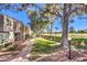 Exterior townhome view with brick pathway and golf course in the background at 1030 Tam O Shanter, Las Vegas, NV 89109