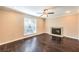 Cozy living room with dark hardwood flooring, a decorative fireplace, and plenty of natural light at 1030 Tam O Shanter, Las Vegas, NV 89109