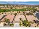 This aerial shot features a well-manicured desert community complete with houses and a golf course at 10372 Premia Pl, Las Vegas, NV 89135