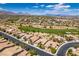 Desert community featuring houses and a golf course and mountain views at 10372 Premia Pl, Las Vegas, NV 89135