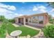 Charming backyard with artificial turf, a covered patio, and low-maintenance landscaping at 10372 Premia Pl, Las Vegas, NV 89135