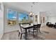 Elegant dining area featuring large windows with scenic views and stylish furnishings at 10372 Premia Pl, Las Vegas, NV 89135