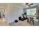 Bright exercise room featuring a treadmill, desk, ceiling fan, and large window for natural lighting at 10372 Premia Pl, Las Vegas, NV 89135