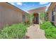 Welcoming front entrance featuring lush landscaping, a covered entryway, and a decorative front door at 10372 Premia Pl, Las Vegas, NV 89135