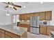 Well-equipped kitchen with granite counters, stainless steel fridge, and abundant cabinetry at 10372 Premia Pl, Las Vegas, NV 89135