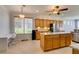 Bright kitchen with granite counters, stainless appliances, tile floors, and island with workspace at 10372 Premia Pl, Las Vegas, NV 89135