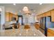 Spacious kitchen with granite countertops, stainless steel appliances, and a central island at 10372 Premia Pl, Las Vegas, NV 89135
