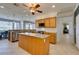 Spacious kitchen features granite countertops, an island, stainless steel appliances, and pendant lighting at 10372 Premia Pl, Las Vegas, NV 89135
