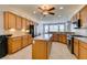 Well-equipped kitchen featuring granite counters, an island, stainless steel appliances and tile flooring at 10372 Premia Pl, Las Vegas, NV 89135