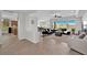 Open-concept living area with tile flooring, a large window, and seamless flow to dining at 10372 Premia Pl, Las Vegas, NV 89135