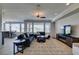Spacious living area open to the dining area with neutral tones and ample natural light at 10372 Premia Pl, Las Vegas, NV 89135