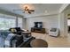 Comfortable living room with tile floors, recessed lighting, ceiling fan, and media center at 10372 Premia Pl, Las Vegas, NV 89135