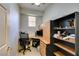 This home office boasts built-in shelving, a corner desk setup, and ample storage space, perfect for productivity at 10372 Premia Pl, Las Vegas, NV 89135