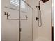 Modern bathroom featuring glass shower with a rainfall shower head and artistic towel rack at 10519 Bella Camrosa Dr, Las Vegas, NV 89141