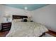 Cozy bedroom design with unique ceiling decor, dark wood furniture, and plush bedding at 10519 Bella Camrosa Dr, Las Vegas, NV 89141
