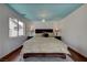 Comfortable bedroom with a light blue ceiling, dark wood bed frame and nightstands at 10519 Bella Camrosa Dr, Las Vegas, NV 89141